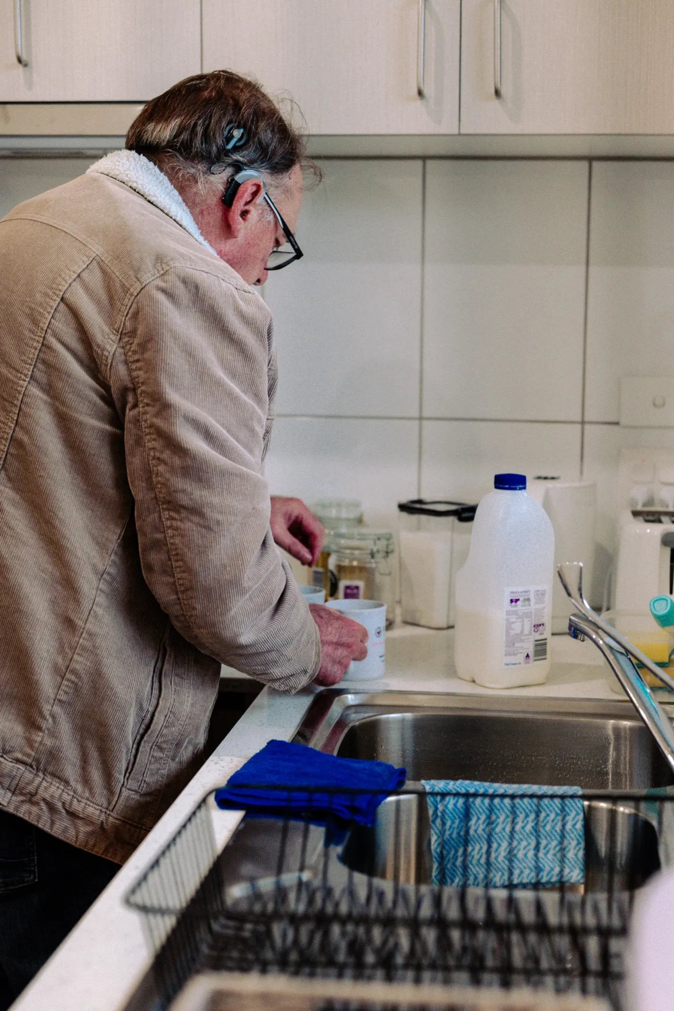 A support worker helping a participant in the kitchen